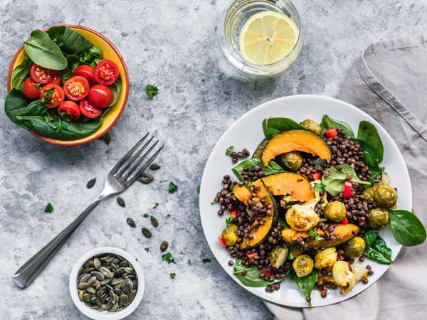 Pumpkin, lentil, spinach and tomatoes on a plate