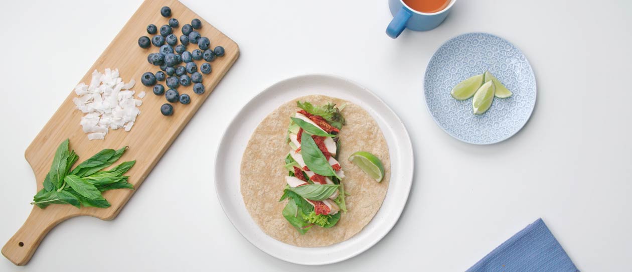 Flat lay of healthy ingredients to make a chicken wrap