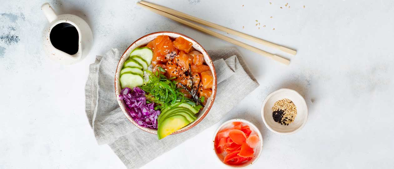 Hawaiian salmon poke bowl with seaweed, avocado, mango, pickled ginger, sesame seeds